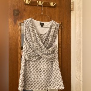 White sleeveless shirt with black design ($8 cash only)